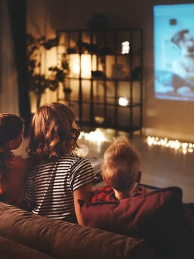 family watching movie at night on a projector.