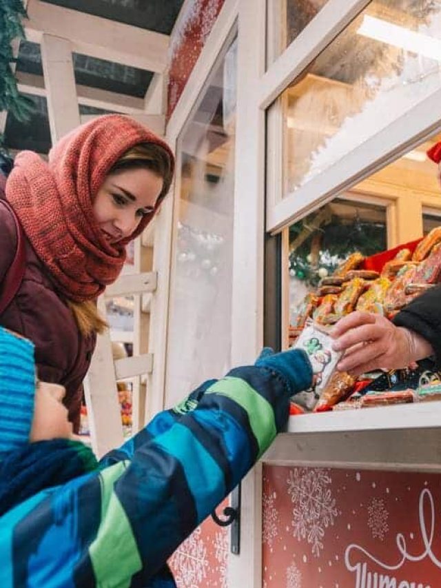 kid with a girl buying sweets during christmas.