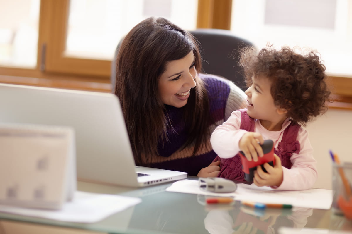 Women working next to daughter.