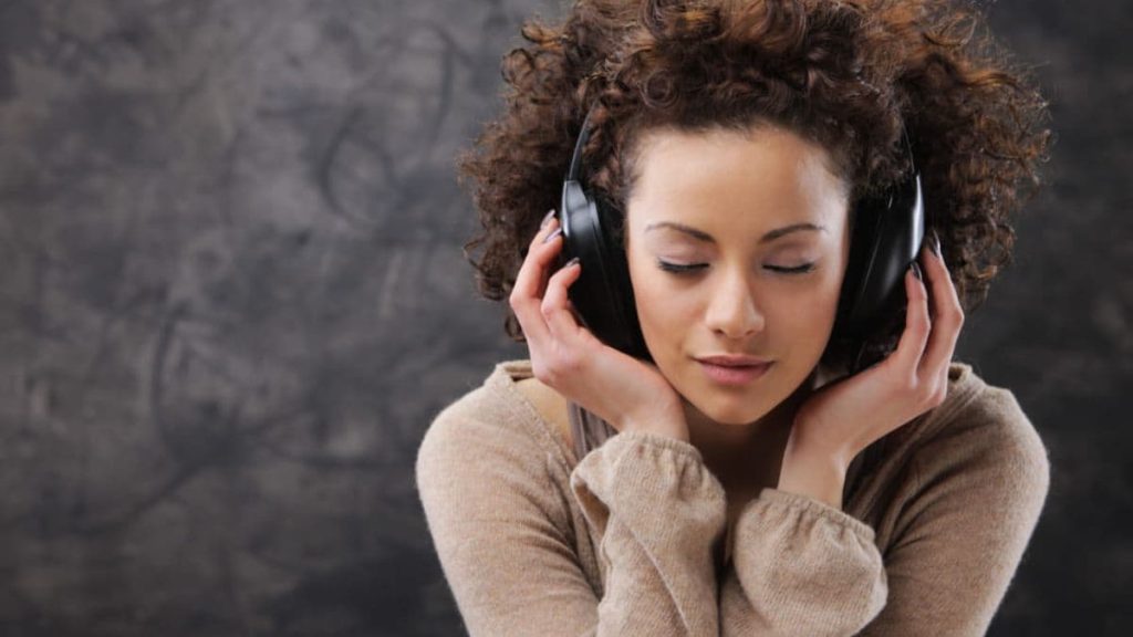 a girl listening to music through her headphones.