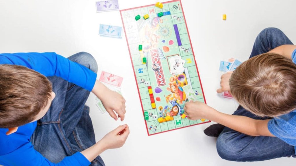 two kids playing monopoly.