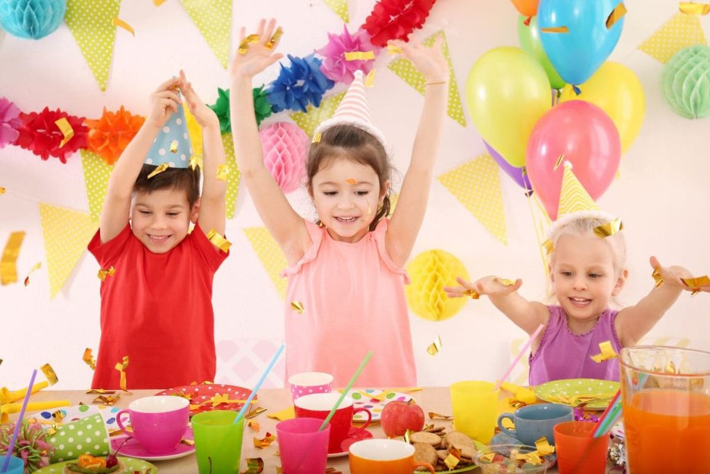 Cute little children celebrating birthday at party.