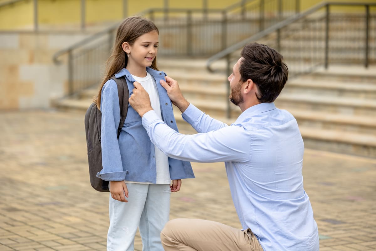 Dad taking his daughter to school.