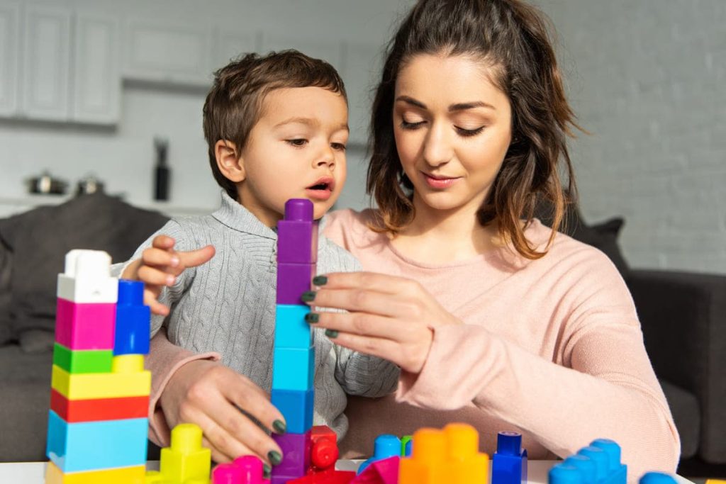 Mother and son playing with blocks together.