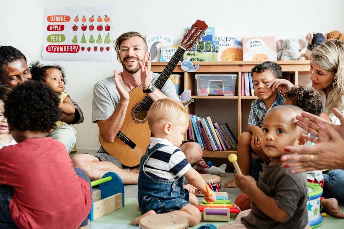 Nursery children playing with musical instruments in the classroom.