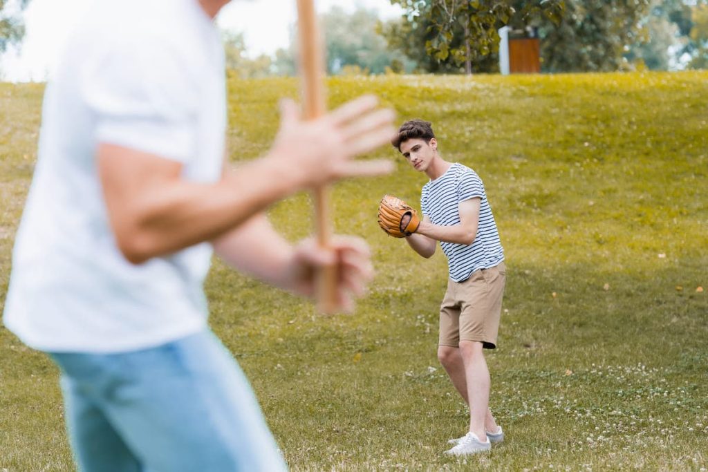 Teenage boy playing baseball.