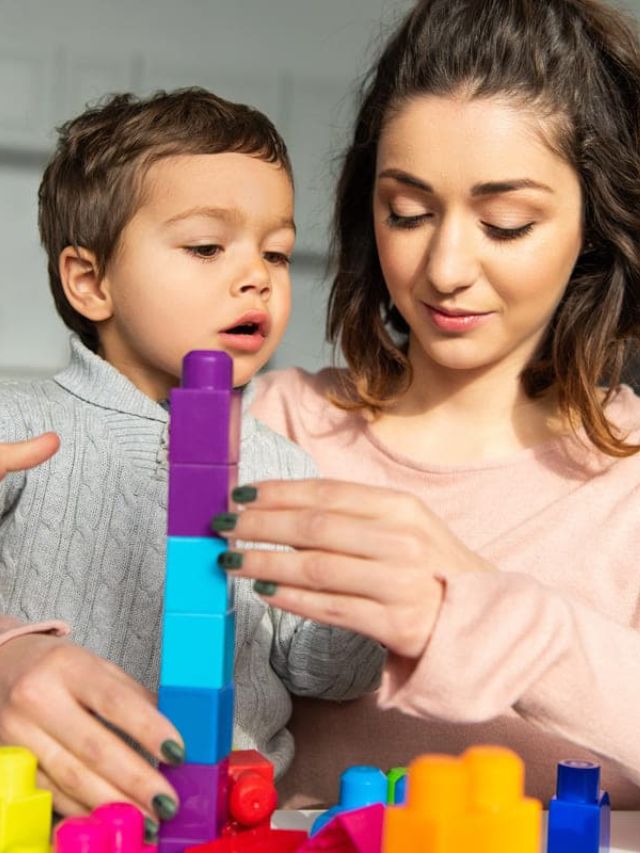 mother and child playing building blocks.