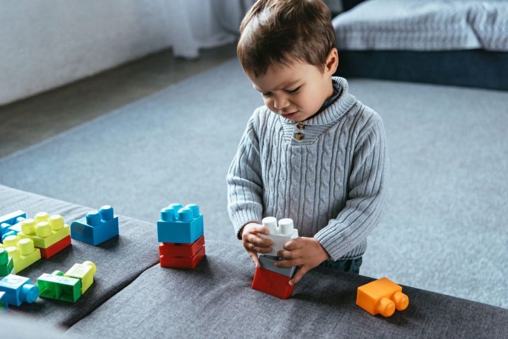 toddler playing lego.