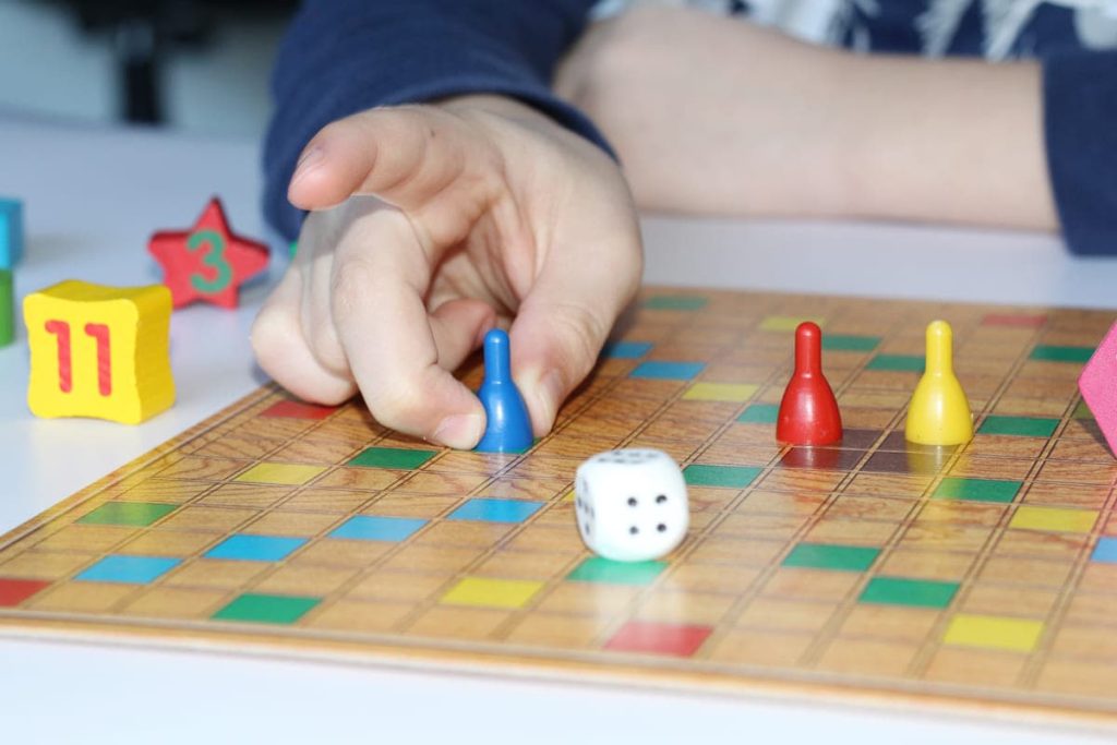 A kids playing a boardgame.