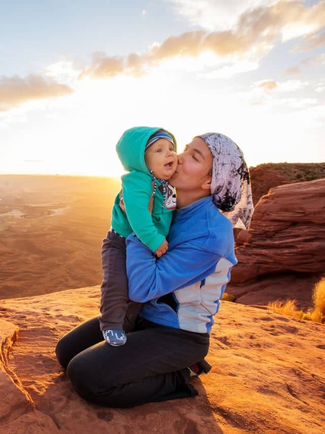 A mother and her baby son visit Canyonlands National park in Utah, USA.