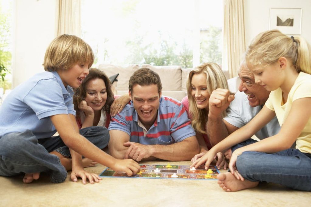 a happy family playing board games at home.
