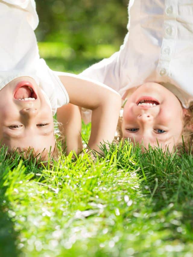 children having fun outdoors in the grass during march spring