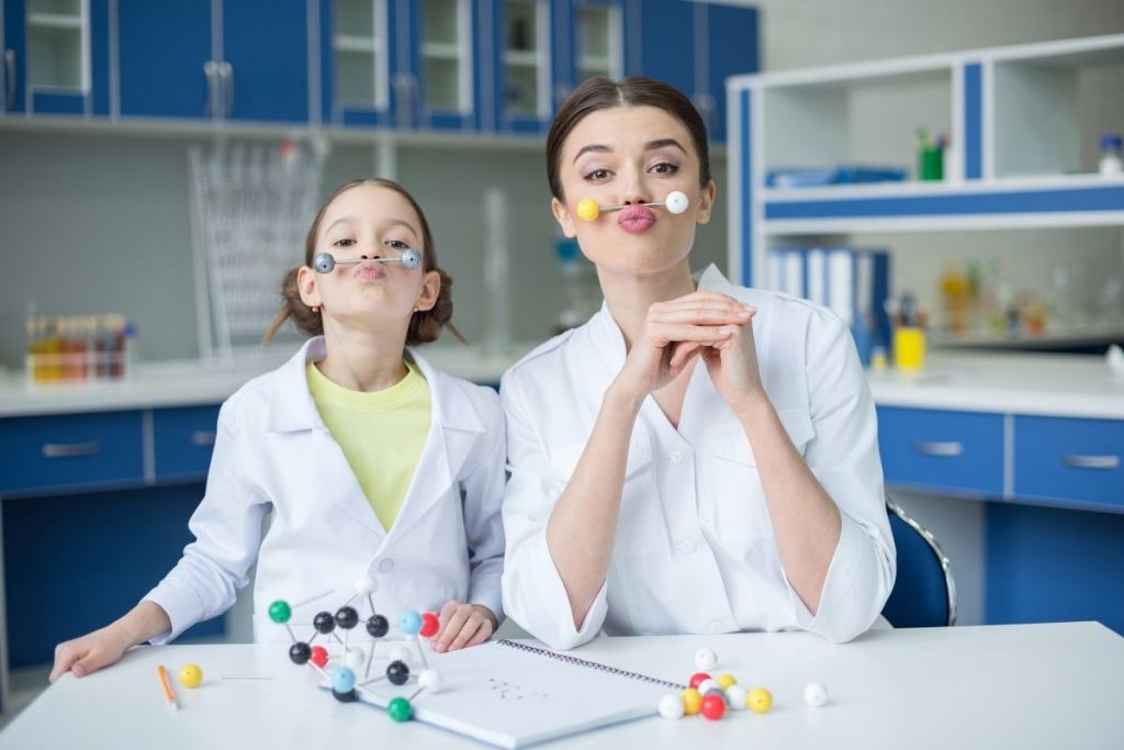 teacher and student in a science lab being playful.