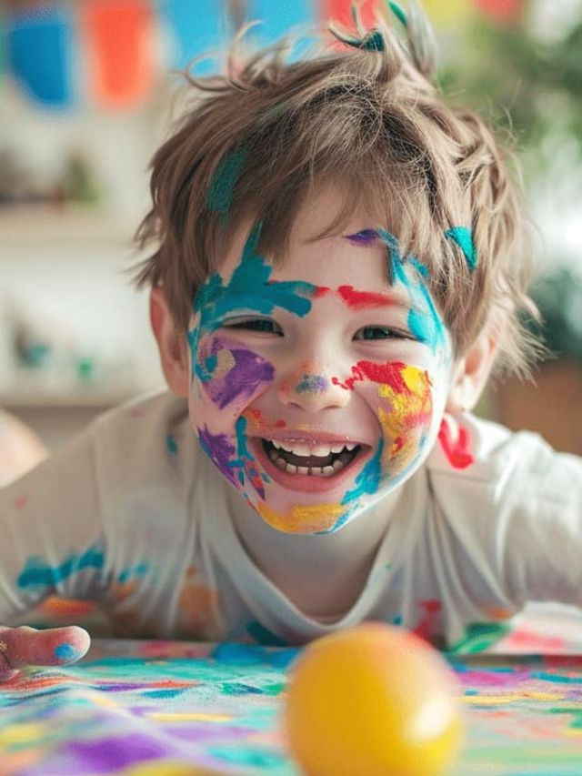 young boy with paint on face.