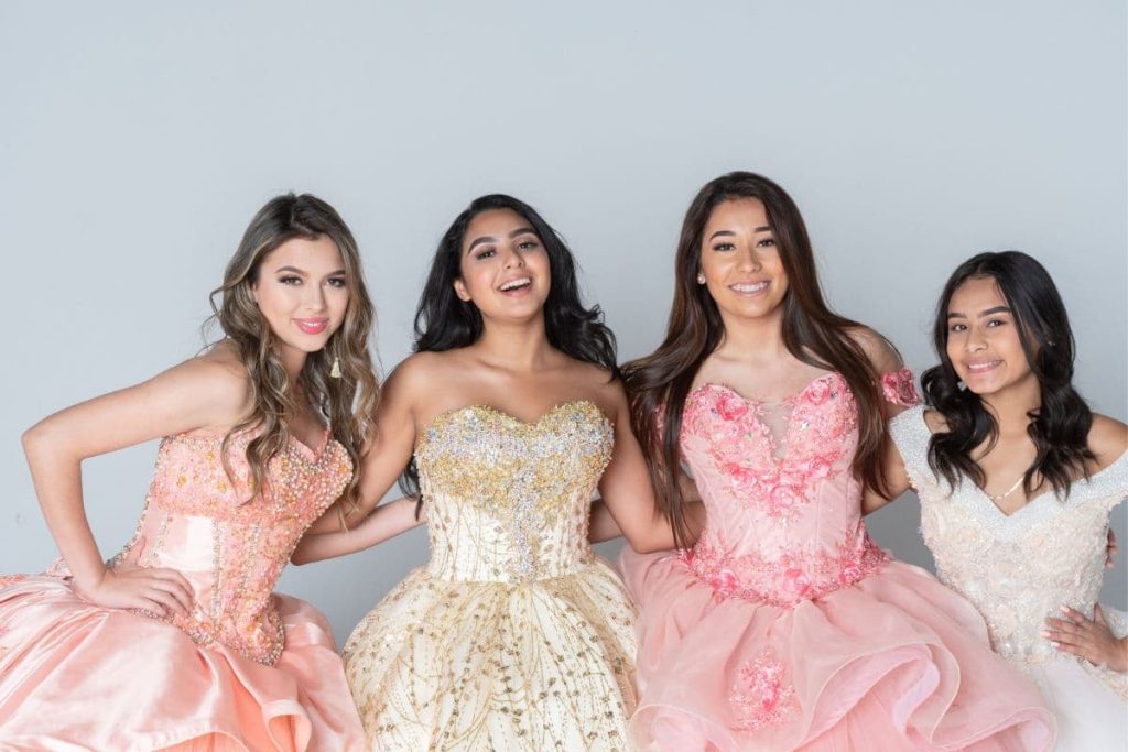Four Hispanic Girls In Quinceanera Dresses.