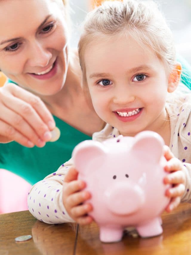 mother and daughter saving money in piggy bank.