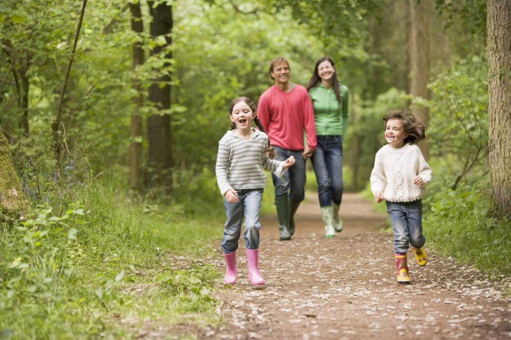 Family waking in the woods during March.