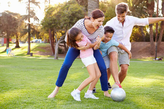 family in park playing.